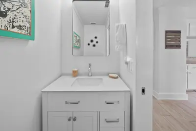 a white bathroom with a sink and a mirror at Three Steps to the Beach l Beachfront l Steps To The Beach l Includes 2 Bikes in Inlet Beach