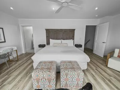 a bedroom with a large white bed and a couch at Three Steps to the Beach l Beachfront l Steps To The Beach l Includes 2 Bikes in Inlet Beach