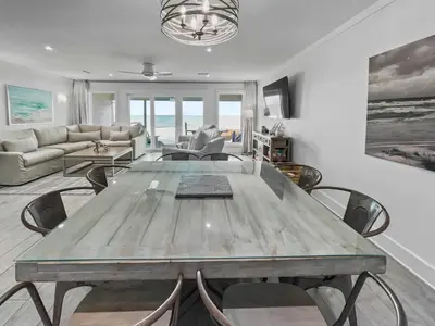 a living room with a wooden table and chairs at Three Steps to the Beach l Beachfront l Steps To The Beach l Includes 2 Bikes in Inlet Beach