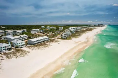 an aerial view of a beach with condos at Three Steps to the Beach l Beachfront l Steps To The Beach l Includes 2 Bikes in Inlet Beach