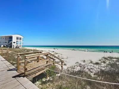 a view of a beach with a house and the ocean at Three Steps to the Beach l Beachfront l Steps To The Beach l Includes 2 Bikes in Inlet Beach