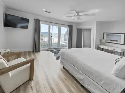 a bedroom with a large bed and a large window at Three Steps to the Beach l Beachfront l Steps To The Beach l Includes 2 Bikes in Inlet Beach