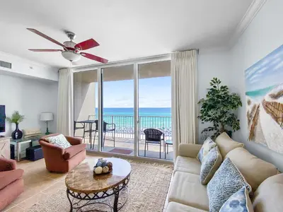 a living room with a view of the ocean at Tidewater 311 l Beachfront with pristine views l Heated Pool & Jacuzzi l Gym and Game room and Theatre in Panama City Beach