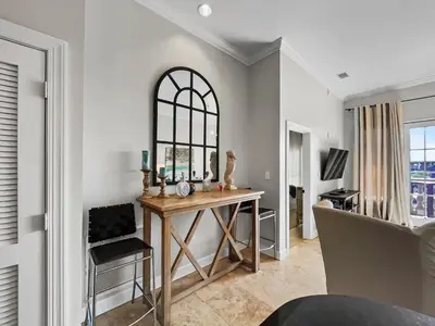 a dining room with a table and a mirror at Twickenham l Heated Community Pool l Private Balcony l Close to Rosemary in Rosemary Beach