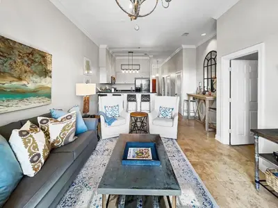 a living room with a couch and a table at Twickenham l Heated Community Pool l Private Balcony l Close to Rosemary in Rosemary Beach