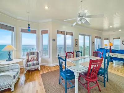 a dining room with a table and chairs at Turtle Watch l Beachfront Pool l Includes Bikes and Beach Chair in Inlet Beach
