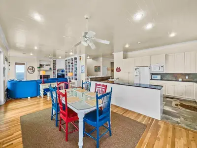 a kitchen with a table and chairs in a room at Turtle Watch l Beachfront Pool l Includes Bikes and Beach Chair in Inlet Beach
