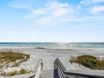 a view of a beach with a wooden boardwalk and the ocean at Turtle Watch l Beachfront Pool l Includes Bikes and Beach Chair in Inlet Beach