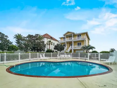 a swimming pool in front of a house at Turtle Watch l Beachfront Pool l Includes Bikes and Beach Chair in Inlet Beach