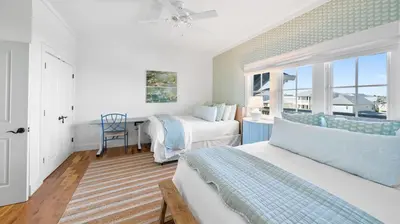 a bedroom with two beds and a window at Vitamin Sea l Beachfront l 4 Bikes Included in Inlet Beach