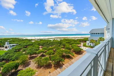 an oceanfront balcony with a view of the beach at Vitamin Sea l Beachfront l 4 Bikes Included in Inlet Beach