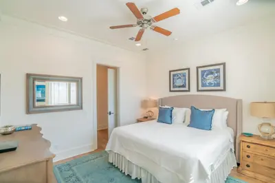 a bedroom with a bed and a ceiling fan at Young Haven l Community Pool l Great Beach house Next to Seaside in Santa Rosa Beach