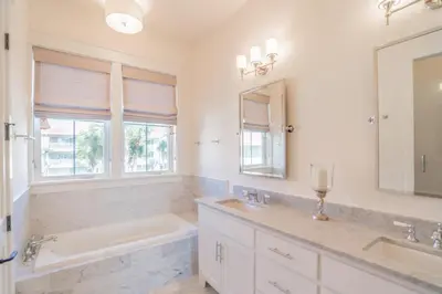 a white bathroom with a tub and a sink and a tub and a mirror at Young Haven l Community Pool l Great Beach house Next to Seaside in Santa Rosa Beach