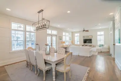 a dining room and living room with a table and chairs at Young Haven l Community Pool l Great Beach house Next to Seaside in Santa Rosa Beach