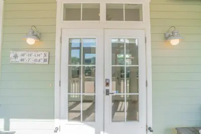 a white door on the side of a house at Young Haven l Community Pool l Great Beach house Next to Seaside in Santa Rosa Beach