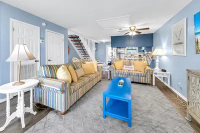 a living room with a couch and a table at Laguna Beach Breeze in Panama City Beach