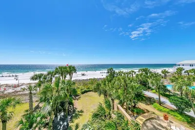 an aerial view of a beach with palm trees and the ocean at Sterling Reef 301 by Emerald Coast Retreats in Panama City Beach