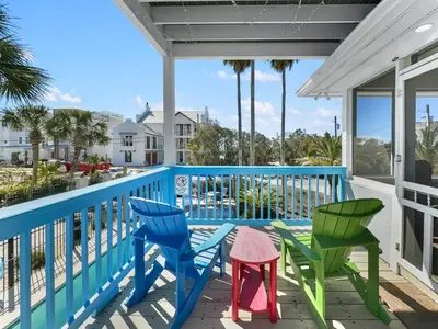 a porch with colorful chairs and a table at Lagerheads l Beach Views l Private Pool l Dog Friendly l Includes 4 Bikes in Inlet Beach
