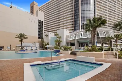 a swimming pool in front of a large building at Laketown Wharf 531 in Panama City Beach