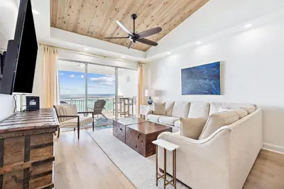 a living room with a couch and a tv at HP 42W Peaceful Nest by 30A Escapes in Rosemary Beach