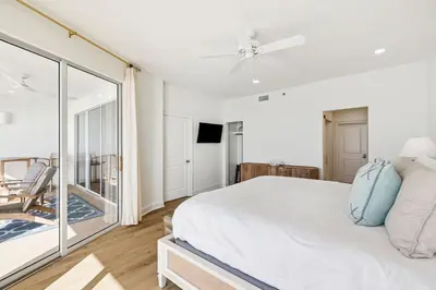 a bedroom with a large bed and a balcony at HP 42W Peaceful Nest by 30A Escapes in Rosemary Beach