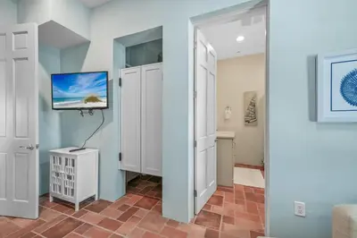 a room with a tv on a wall at Luxury Rosemary 4BR Villa with Private Pool in Rosemary Beach