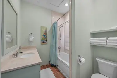 a bathroom with a sink and a toilet and a tub at Luxury Rosemary 4BR Villa with Private Pool in Rosemary Beach