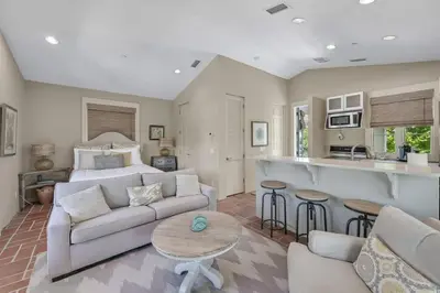 a living room with a couch and a kitchen at Luxury Rosemary 4BR Villa with Private Pool in Rosemary Beach