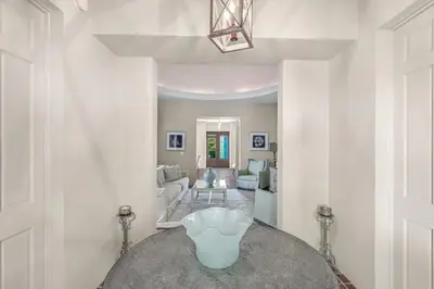 a living room with a vase on a table at Luxury Rosemary 4BR Villa with Private Pool in Rosemary Beach