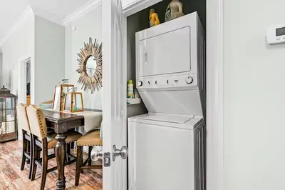 a kitchen and dining room with a table and a refrigerator at Paradise 2205 in Santa Rosa Beach
