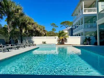 a swimming pool in front of a building at Pelican Perch in Seagrove Beach