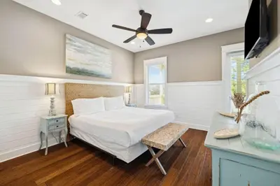 a bedroom with a bed and a ceiling fan at Pelican Perch in Seagrove Beach