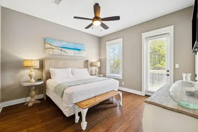 a bedroom with a bed and a ceiling fan at Pelican Perch in Seagrove Beach