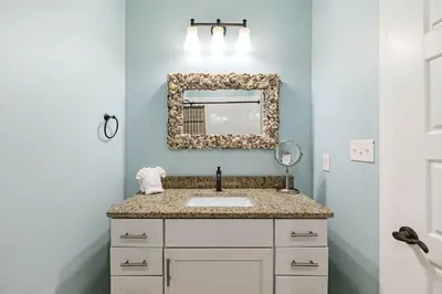 a bathroom with a sink and a mirror at Pelican Perch in Seagrove Beach