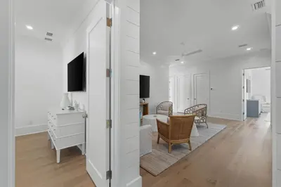 a white living room with a table and chairs at Anchors Aweigh in Seacrest