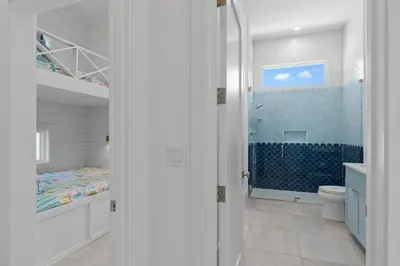 a bathroom with a bed and a shower and a toilet at Anchors Aweigh in Seacrest