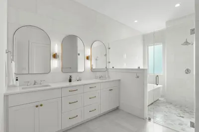 a white bathroom with two sinks and a tub at Anchors Aweigh in Seacrest