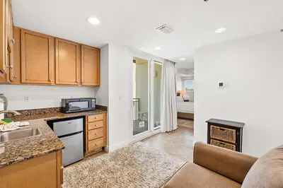 a kitchen and living room with a couch at Sterling Breeze 307A by Emerald Coast Retreats in Panama City Beach
