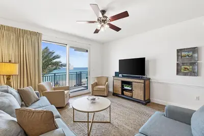 a living room with a couch and a tv at Sterling Breeze 307B by Emerald Coast Retreats in Panama City Beach