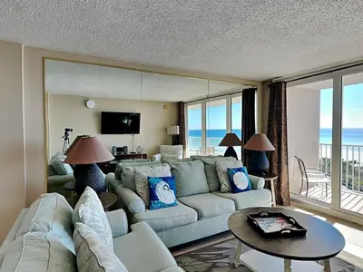 a living room with a couch and a table at Dunes of Panama #B501 in Panama City Beach