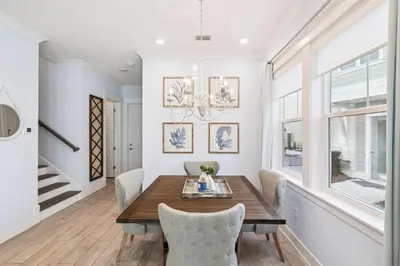 a dining room with a wooden table and chairs at Blue Dreams 125 W Pine Lands Loop Unit A in Inlet Beach