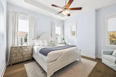 a bedroom with a bed and a ceiling fan at Blue Dreams 125 W Pine Lands Loop Unit A in Inlet Beach