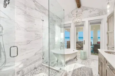 a bathroom with a shower and a tub and a sink at Gulf Royale 30A in Inlet Beach