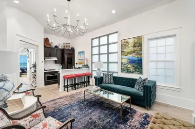 a living room with a couch and a table at Gulf Royale 30A in Inlet Beach
