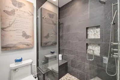 a bathroom with a shower and a white toilet at Gulf Royale 30A in Inlet Beach