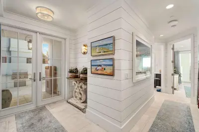 a white room with a wall with paintings on it at Gulf Royale 30A in Inlet Beach