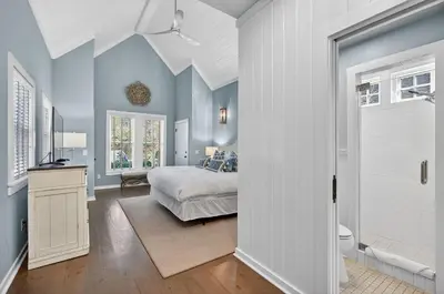 a bedroom with blue walls and a bed and a bathroom at 231 Saltbox Lane - Near Beach Home with Community Pool in Watersound in Watersound Beach