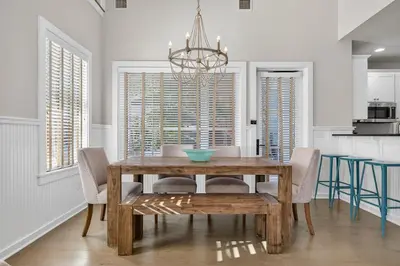 a dining room with a wooden table and chairs at 231 Saltbox Lane - Near Beach Home with Community Pool in Watersound in Watersound Beach