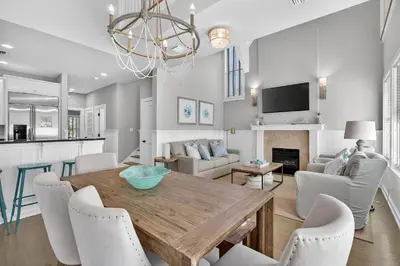 a dining room and living room with a table and chairs at 231 Saltbox Lane - Near Beach Home with Community Pool in Watersound in Watersound Beach