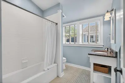 a bathroom with a tub and a toilet and a sink at 231 Saltbox Lane - Near Beach Home with Community Pool in Watersound in Watersound Beach